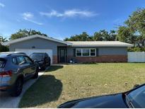 Charming single-story home with brick accents, lush lawn, and well-maintained landscaping at 2198 Academy Dr, Clearwater, FL 33764
