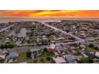 Beautiful waterfront home with a large lot, boat dock, and stunning sunset views over the water at 4299 Bellaire Dr, Hernando Beach, FL 34607
