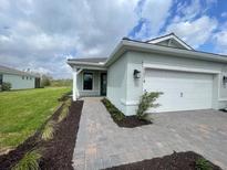 Charming single-story home with a two-car garage, brick walkway, and well-maintained landscaping at 5014 Coastal Oak Ct, Lakewood Ranch, FL 34211