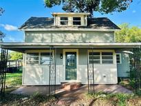 Charming two-story home with covered front porch and decorative iron railings at 5654 12Th St, Zephyrhills, FL 33542