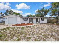 Charming single-story home featuring a front yard and attached garage at 11130 White Oak Ln, Port Richey, FL 34668