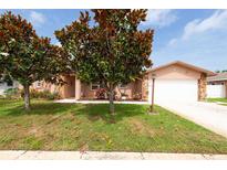 Charming single-Gathering home featuring a well-manicured lawn and inviting curb appeal with mature magnolia trees at 12946 116Th St, Largo, FL 33778