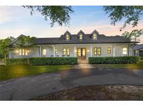 Well-maintained home with manicured front lawn and inviting covered porch at 18577 Clay Hill Rd, Dade City, FL 33523