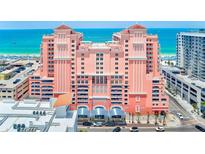 Stunning view of the pink beachfront condo with balconies and ocean view at 301 S Gulfview Blvd # 301, Clearwater Beach, FL 33767