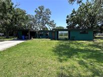 Charming single-story home with a well-manicured lawn and mature trees in a suburban setting at 314 Dickman Sw Dr, Ruskin, FL 33570