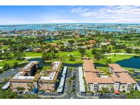 Stunning aerial view of condos overlooking a golf course, lakes, and the ocean at 6100 Gulfport S Blvd # 114, Gulfport, FL 33707