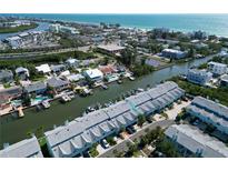 Beautiful aerial view of waterfront townhomes with boat docks and easy access to the bay and gulf beaches at 659 Garland Cir, Indian Rocks Beach, FL 33785