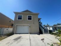 Two-story home with a one-car garage and exterior staircase at 7330 New York Ave, Hudson, FL 34667