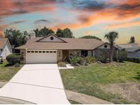 Beautiful single-Gathering home showcasing manicured lawn, brick accents, and two-car garage at 8521 Caitlin Ct, Hudson, FL 34667