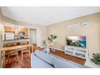 Bright living room with wood floors, neutral paint, and an open layout to the kitchen at 11901 4Th N St # 5111, St Petersburg, FL 33716