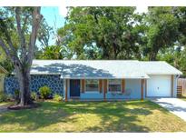 Charming single-story home with a beautifully landscaped front yard and attached garage at 2750 Edenwood St, Clearwater, FL 33759