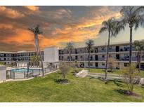 Beautiful condo complex featuring a pool, shuffleboard court, and lush landscaping at 4050 4Th N St # 205, St Petersburg, FL 33703