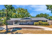 Charming single-story home features a gray exterior, well-manicured landscaping, and a welcoming front porch at 504 7Th Sw Ave, Largo, FL 33770