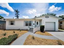 Charming single-story home with well-maintained landscaping and inviting curb appeal on a sunny day at 5642 9Th N Ave, St Petersburg, FL 33710