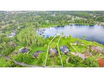 Exceptional lakefront home with a private pool surrounded by lush landscaping at 707 Warren Rd, Lutz, FL 33548