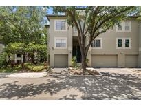 Charming townhome with two-car garage and mature tree in landscaped front yard at 727 Coral Reef Dr, Tampa, FL 33602