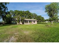 Charming single-story home with a spacious front yard and mature trees at 10818 Land O Lakes Blvd, Land O Lakes, FL 34638
