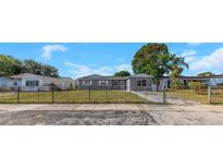 Charming single-story home with fenced front yard and a mix of stone and siding accents at 11809 129Th Ave, Largo, FL 33778