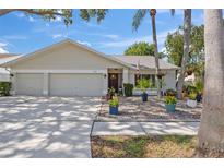 Charming single-story home with a well-manicured lawn and a three-car garage at 11927 Steppingstone Blvd, Tampa, FL 33635