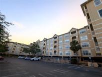 Low-angle of the exterior of this beige multiple-story building with parking, blue sky in the background at 1216 S Missouri Ave # 223, Clearwater, FL 33756