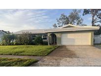 Charming single-story home with a well-manicured lawn and a two-car garage at 13000 90Th Ave, Seminole, FL 33776