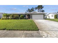 Charming single-story home with a well-manicured lawn and an attached two-car garage at 13000 90Th Ave, Seminole, FL 33776