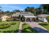 Charming single-Gathering home with a manicured lawn and a two-car attached garage at 2134 Serpentine S Cir, St Petersburg, FL 33712