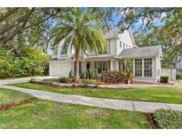Charming two-story home with a manicured lawn, mature trees, and a well-maintained exterior at 2403 W Sunset Dr, Tampa, FL 33629