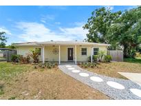 Charming one-story home featuring stone pathway and covered entryway at 3919 W Paxton Ave, Tampa, FL 33611