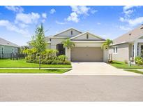 Charming single-story home with a well-manicured lawn and tropical landscaping in a bright, sunny setting at 6097 Golden Nettle Dr, Apollo Beach, FL 33572