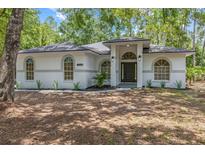 Well-maintained home with a front yard and stylish architectural details at 7644 Conrad St, Wesley Chapel, FL 33544