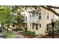 Charming townhomes feature colorful facades, small balconies, and landscaped front yards at 918 Sombra Street, Tampa, FL 33619