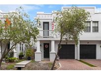 Charming two-story home features a balcony, columns, and a two-car garage at 109 S Packwood Ave # B, Tampa, FL 33606