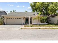 Charming one-story home with a well-maintained lawn and attached two-car garage at 10900 Livingston Dr, New Port Richey, FL 34654