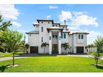 Stunning multi-story modern home featuring manicured lawn and two-car garage in a desirable neighborhood at 110 Carlyle Dr, Palm Harbor, FL 34683