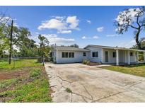 Charming single-story home with a long driveway and mature trees in a serene neighborhood at 1110 Canal St, Ruskin, FL 33570