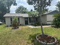 Charming single story home with mature trees and a well-maintained front yard at 116 Cranbrooke Dr, Seffner, FL 33584