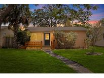 Charming single-story home featuring a stone pathway, manicured lawn, and inviting front porch at 131 44Th N Ave, St Petersburg, FL 33703