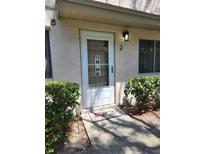 Charming front door with welcome mat and decorative signage near well-maintained landscaping at 1833 Bough Ave # 2, Clearwater, FL 33760
