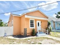 Charming single-story home featuring a stucco exterior, inviting front entrance, and well-maintained landscaping at 2137 W Saint Louis St, Tampa, FL 33607