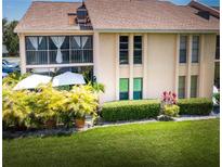 Two-story condo featuring a balcony, well-kept lawn, and lush landscaping at 2335 Beneva Ter # 2254, Sarasota, FL 34232
