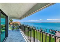 Enjoy beautiful waterfront views from this spacious balcony with outdoor seating area at 240 Sand Key Estates Dr # 222, Clearwater, FL 33767