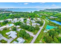 Breathtaking aerial view of the community featuring a pool, tennis court and bay views at 3229 40Th S Ln # C, St Petersburg, FL 33711