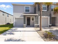 Two-story townhome featuring a one-car garage and covered front entry at 3334 Pleasant Willow Ct, Brandon, FL 33511