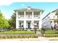Charming two-story home with a welcoming porch, a well-manicured lawn, and decorative landscaping at 702 34Th N Ave, St Petersburg, FL 33704