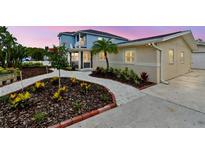 Charming home featuring attractive landscaping, a well-maintained lawn, and a welcoming facade at 807 Illinois Ave, Palm Harbor, FL 34683