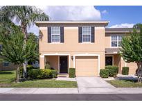 Charming townhome with a well-manicured lawn, black shutters and a one car garage at 8415 Edgewater Place Blvd, Tampa, FL 33615