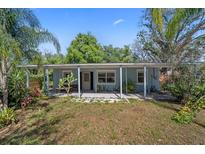 Charming single-story home with a well-maintained lawn and inviting front porch at 12304 Woodleigh Ave, Tampa, FL 33612