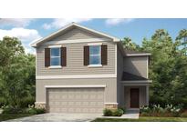 Charming two-story home with a two-car garage, manicured lawn, and welcoming front entrance at 13221 Tropical Breeze Way, Hudson, FL 34669