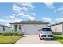 Charming single-story home with a well-manicured lawn and inviting curb appeal, perfect for a starter Gathering at 13958 Richland Gulf Cir, Parrish, FL 34219